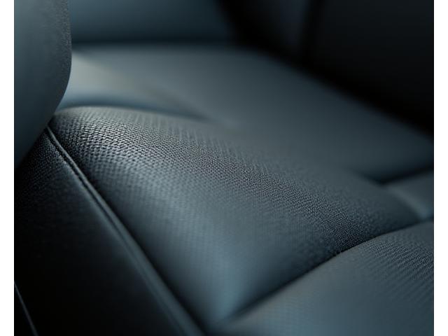Close-up of a luxurious car interior with newly installed sustainable upholstery, pristine and well-crafted details.